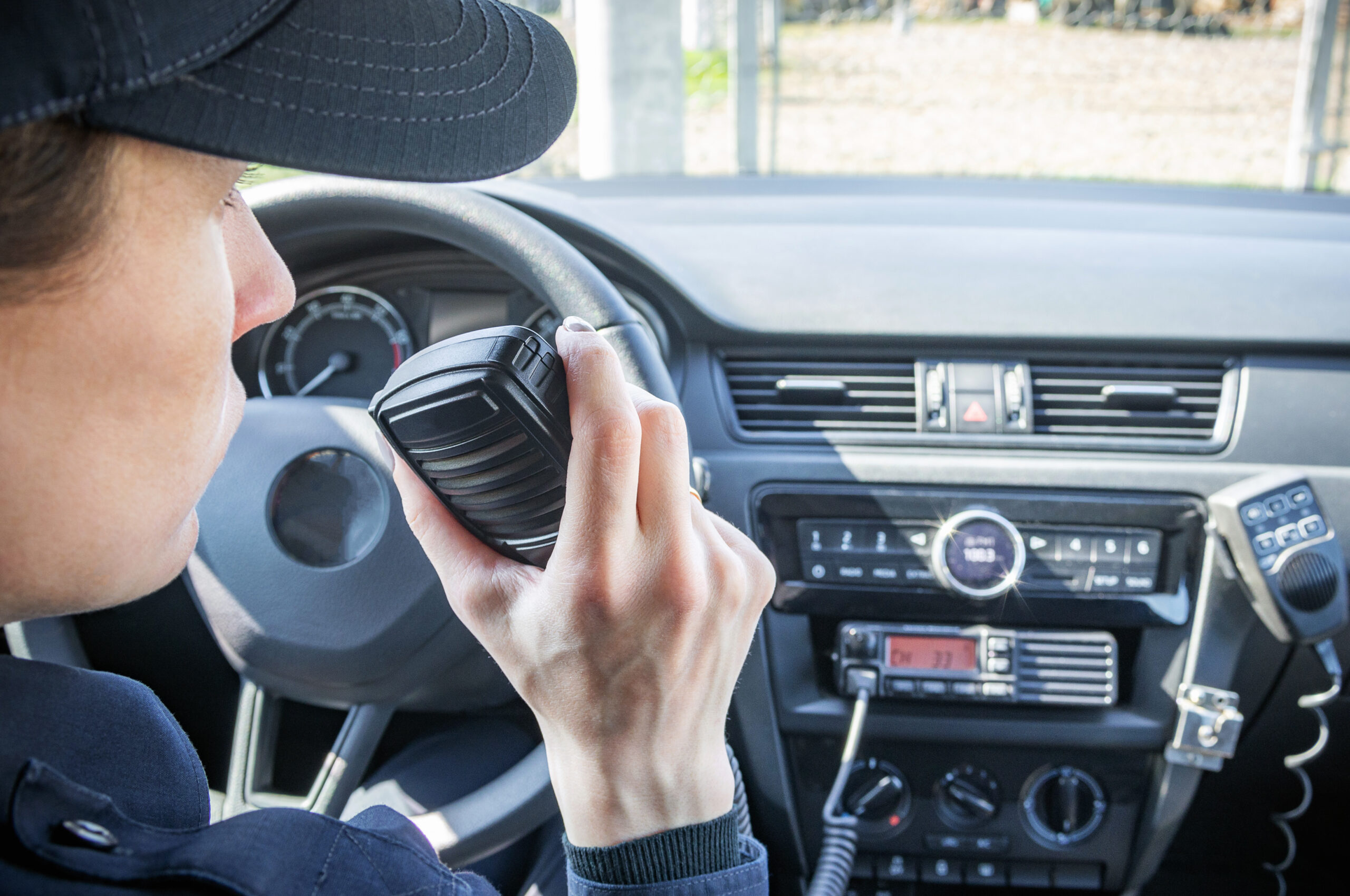 Microphone of a radio or walkie-talkie in the hand of a female p